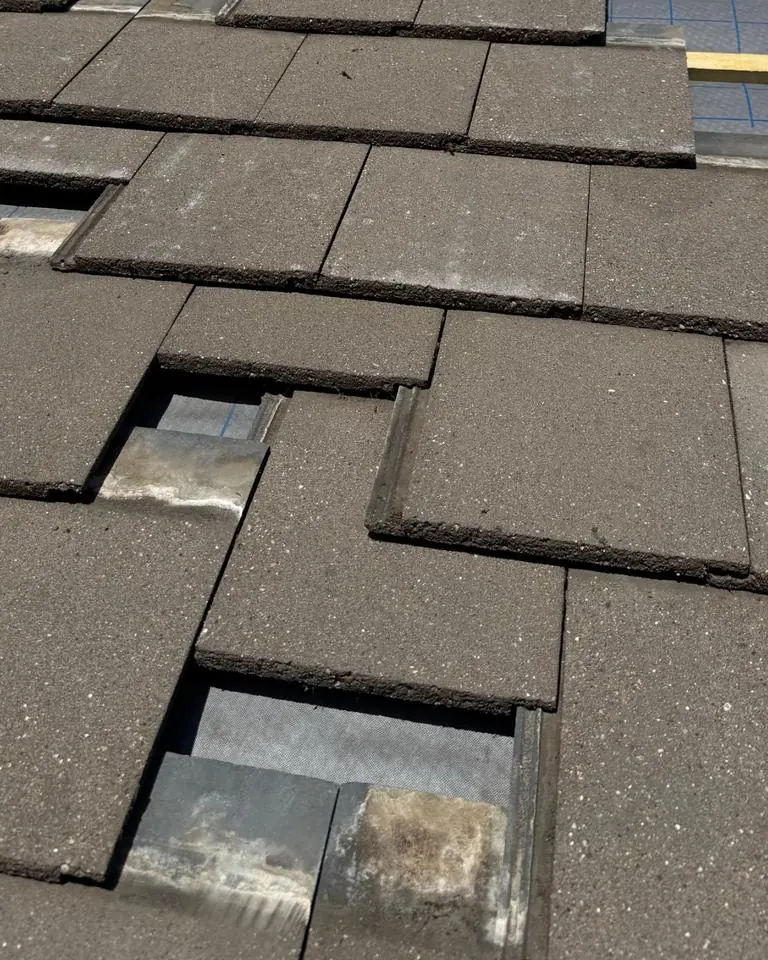 Roof with broken and missing tiles, the kind of damage our free Weekend Roof Clinic helps vulnerable residents with