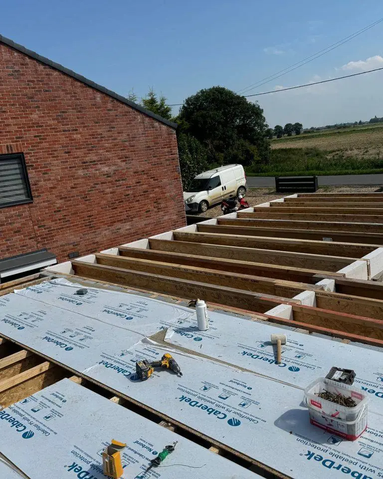 New flat roof deck being laid on engineered joists for a new-build extension
