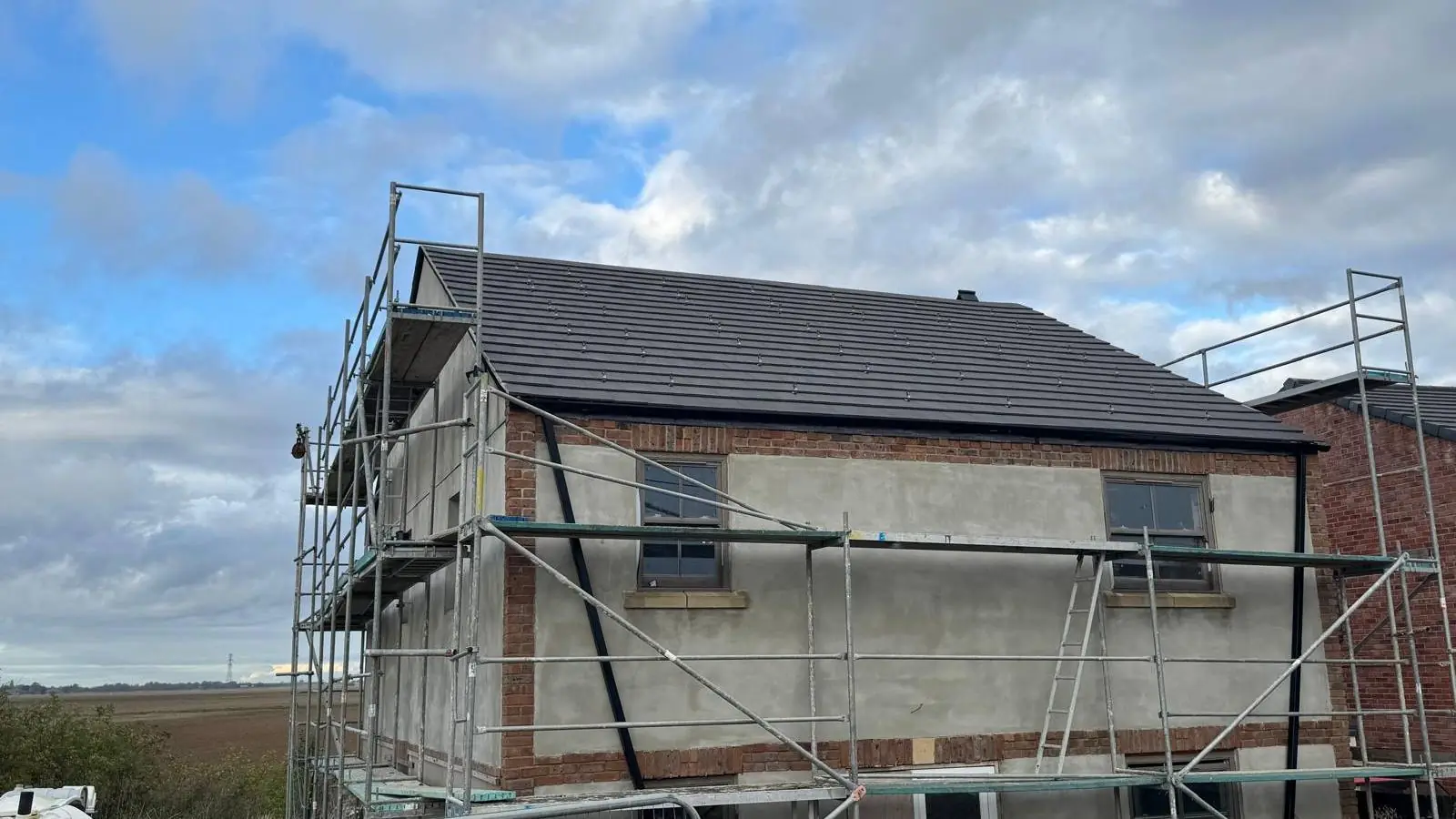 New-build house roof tiled by Upsize in Spalding, with scaffold