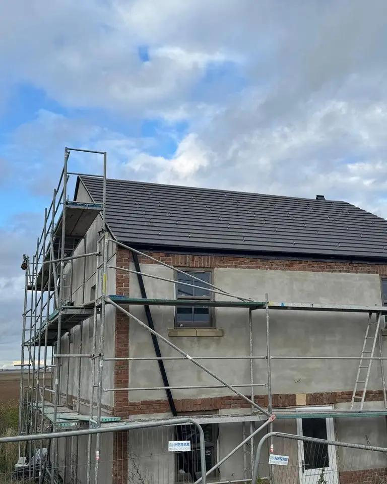 New-build house roof tiled by Upsize in Spalding, scaffold still in place