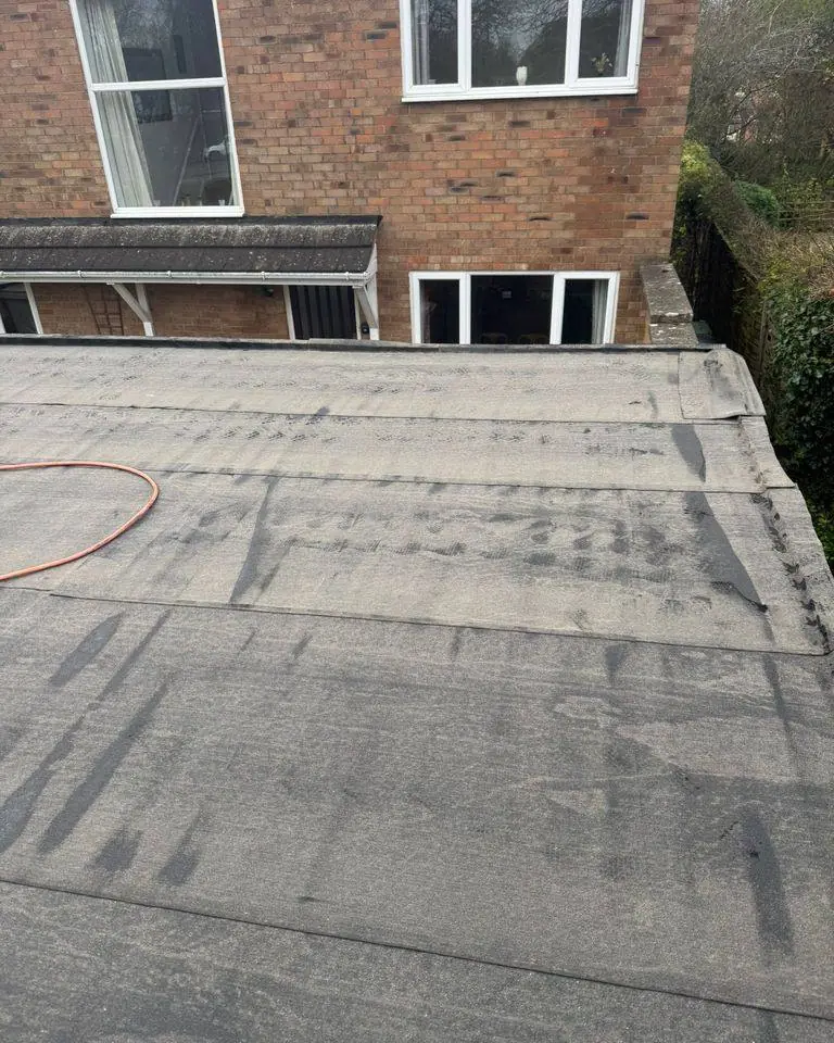 Extension felt flat roof with many patched repairs before replacement