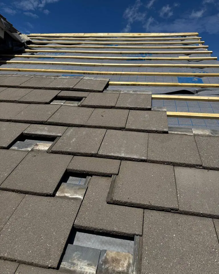 Roof slope relaid with new breathable membrane, battens and concrete tiles
