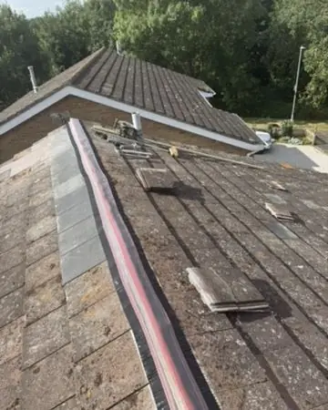 New concrete tiles going on over breathable membrane and battens during a re-roof