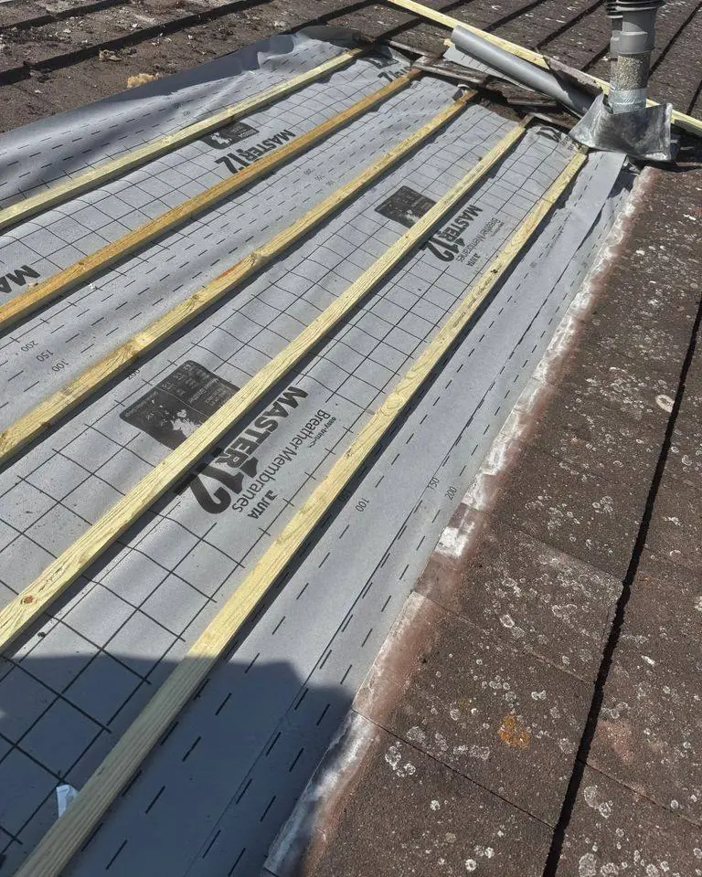 Section of tiled roof relaid with new breathable membrane and battens