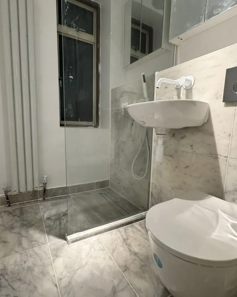 Marble-effect bathroom with walk-in shower and wall-hung basin, Peterborough